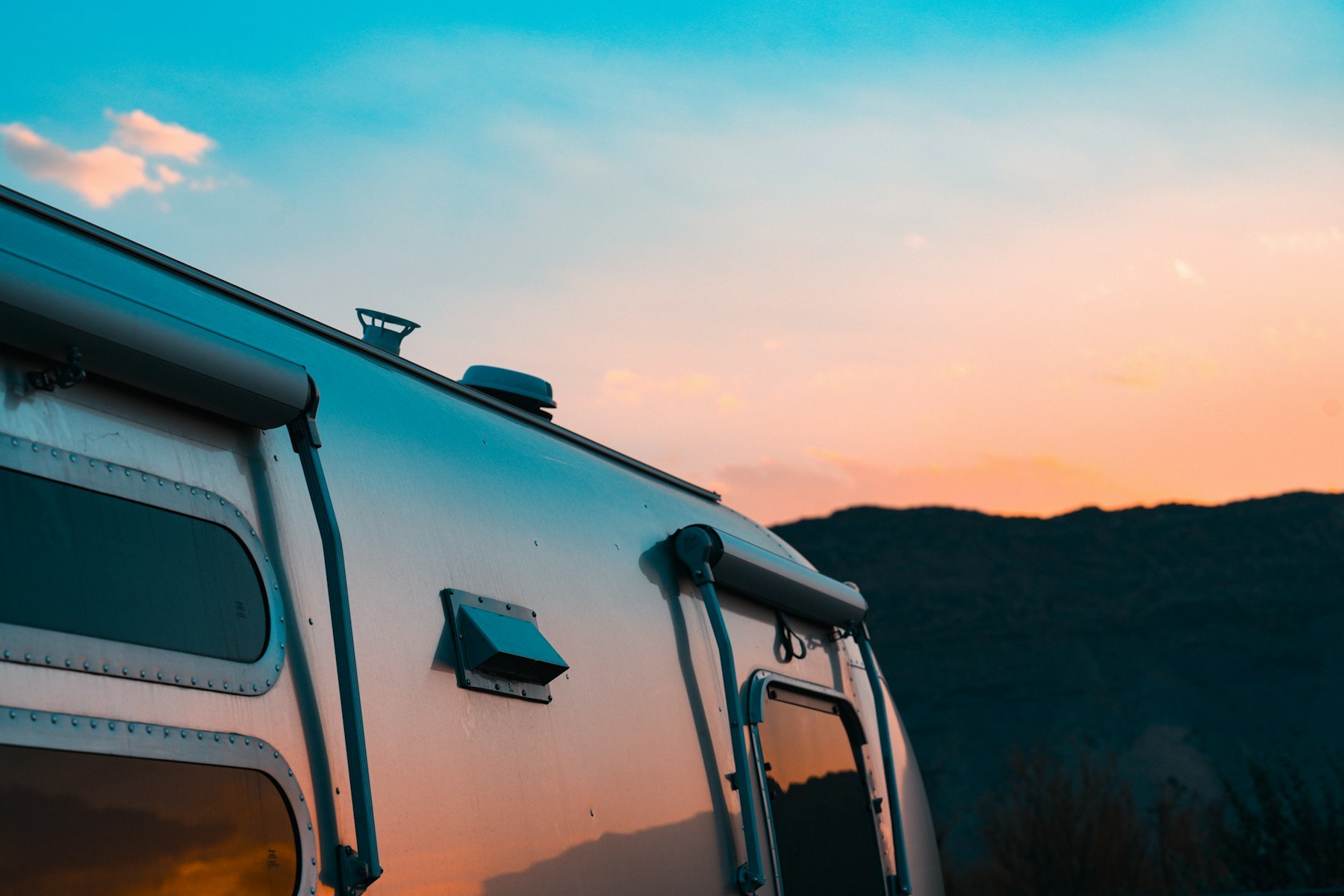 An Airstream trailer under a warm sunset